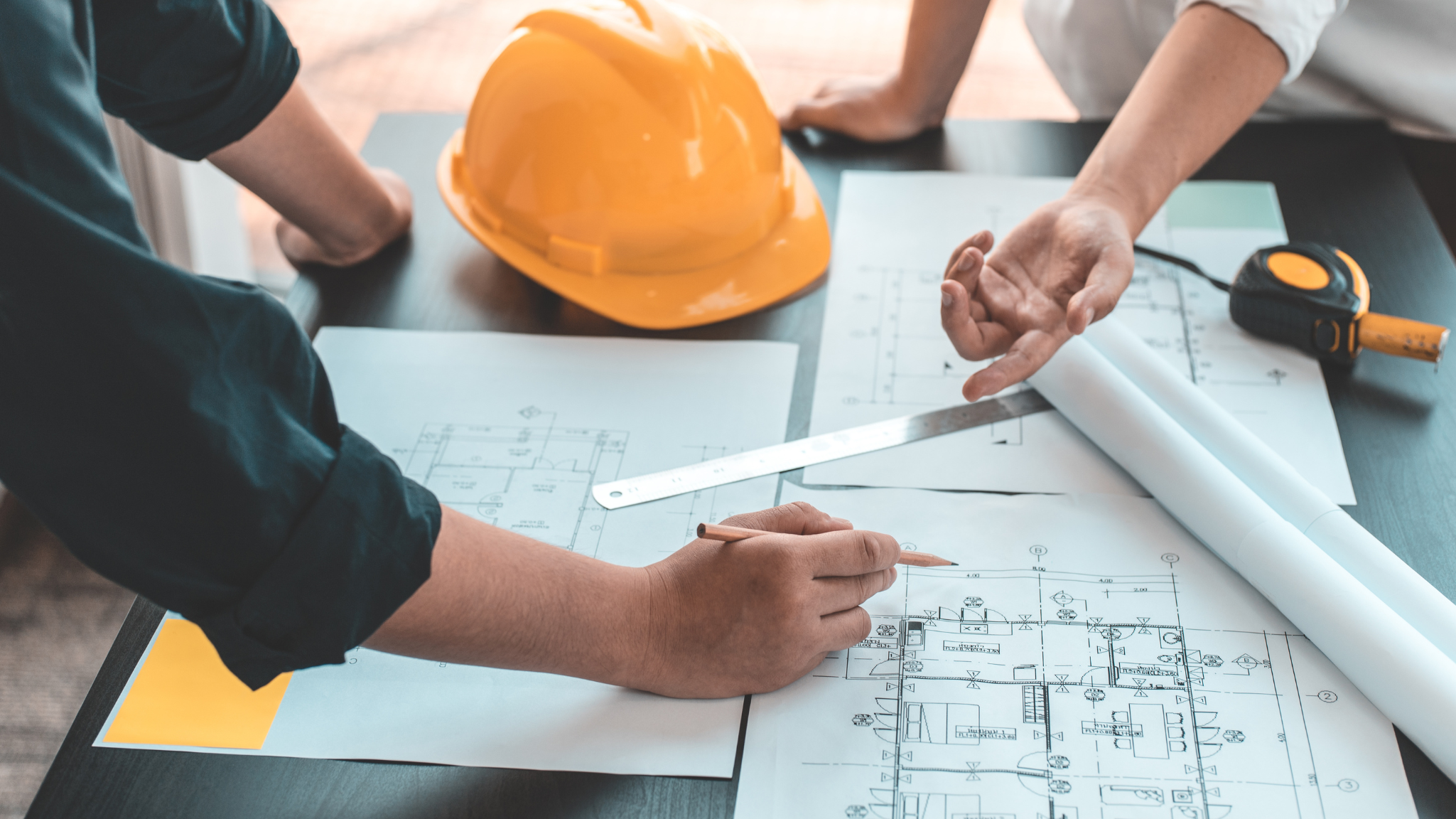 Engineers reviewing building design plans to ensure compliance with ASHRAE Standards for indoor air quality and safety.