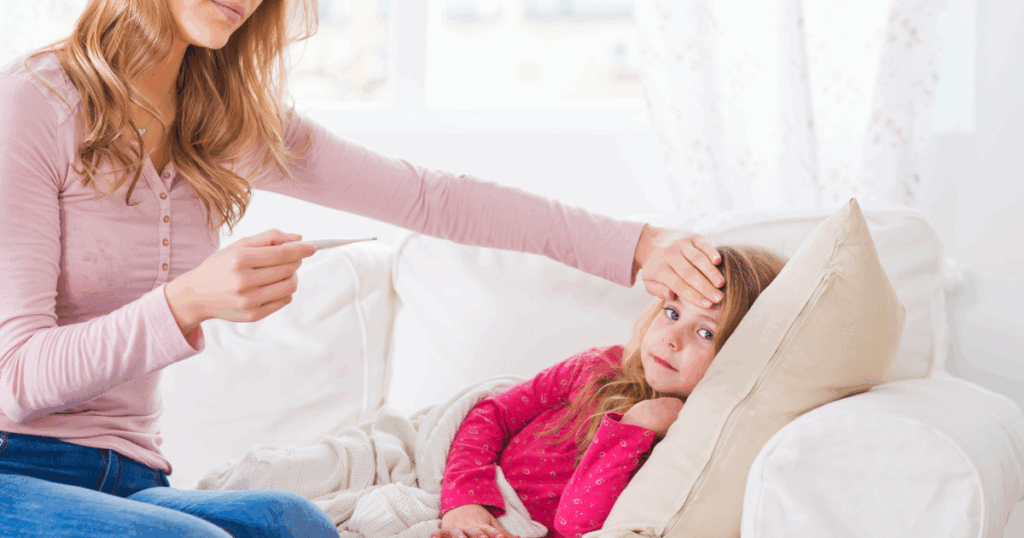 Mother checking daughter's temperature at home, unaware of asymptomatic contagion risks.